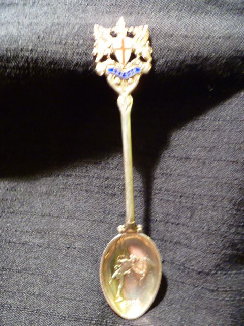 London Sterling spoon with Enameled Coat of Arms & Eros in Relief 